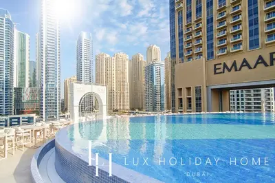 a large swimming pool in the middle of a city at LUX The JW Marina Suite in Dubai