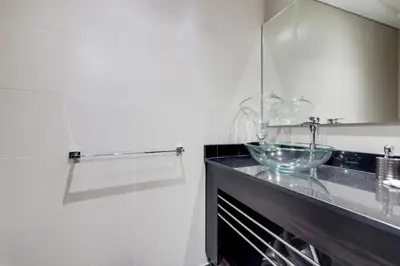 a bathroom with a sink and a glass bowl on a counter at Cayan Tower, Dubai Marina - Charming One Bedroom in Dubai