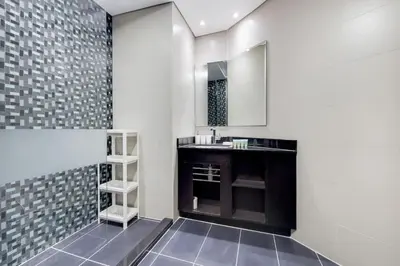 a bathroom with a sink and a mirror at Cayan Tower, Dubai Marina - Charming One Bedroom in Dubai