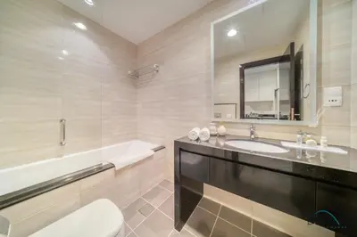 a bathroom with a sink and a tub and a mirror at Lively Studio at DAMAC Celestia A Dubai South by Deluxe Holiday Homes in Dubai