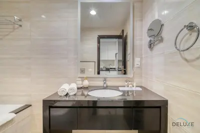 a bathroom with a sink and a mirror at Lively Studio at DAMAC Celestia A Dubai South by Deluxe Holiday Homes in Dubai