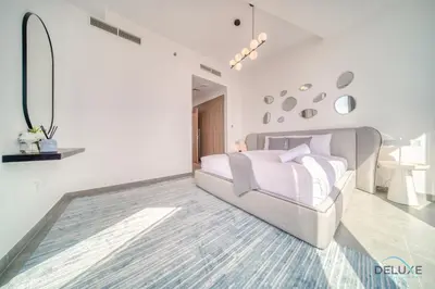 a white bedroom with a bed and a couch at Cosmopolitan 2BR at Stella Maris Dubai Marina by Deluxe Holiday Homes in Dubai