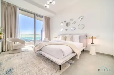 a white bedroom with a bed and a large window at Cosmopolitan 2BR at Stella Maris Dubai Marina by Deluxe Holiday Homes in Dubai