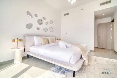 a bedroom with a white bed in a room at Cosmopolitan 2BR at Stella Maris Dubai Marina by Deluxe Holiday Homes in Dubai