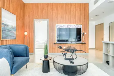 a living room with a blue couch and a table at Spacious 1 Bed Apt - Stella Maris at Dubai Marina By PK Holidays in Dubai