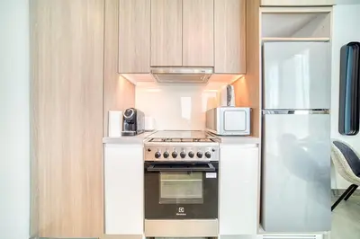 a kitchen with a stove top oven next to a refrigerator at Spacious 1 Bed Apt - Stella Maris at Dubai Marina By PK Holidays in Dubai
