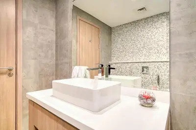 a bathroom with a white sink and a tub at Spacious 1 Bed Apt - Stella Maris at Dubai Marina By PK Holidays in Dubai