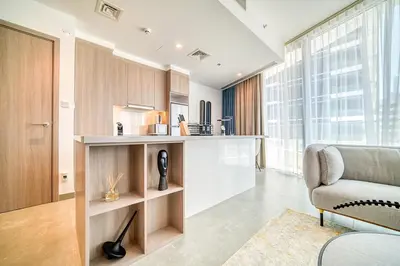 a living room with a couch and a chair at Spacious 1 Bed Apt - Stella Maris at Dubai Marina By PK Holidays in Dubai