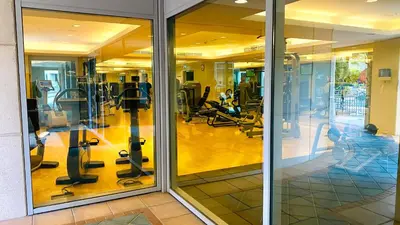 a gym with treadmills and people exercising in the gym at INA Homes-Residences Tower 7 Full Burj Khalifa & Fountain Views in Dubai