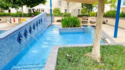 a swimming pool with a water fountain at INA Homes-Residences Tower 7 Full Burj Khalifa & Fountain Views in Dubai