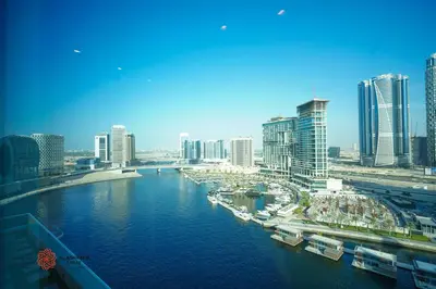 a view of a city with a river and buildings at Modern Spacious 2BR Canal View -Business Bay in Dubai