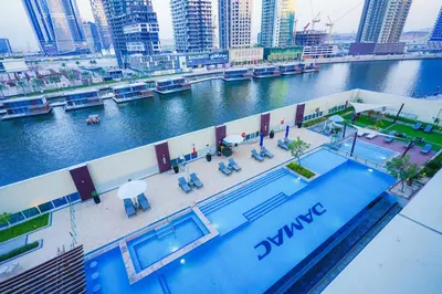 an overhead view of a river with a swimming pool at Modern Spacious 2BR Canal View -Business Bay in Dubai