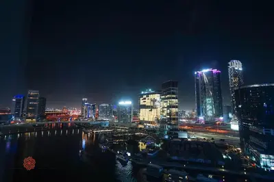 a view of a city at night with buildings at Modern Spacious 2BR Canal View -Business Bay in Dubai
