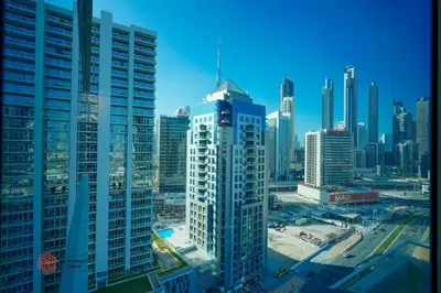 a view of a city skyline with tall buildings at Modern Spacious 2BR Canal View -Business Bay in Dubai