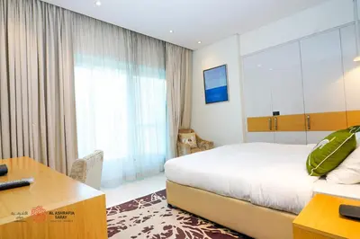 a hotel room with a bed and a desk and a desk at Modern Spacious 2BR Canal View -Business Bay in Dubai