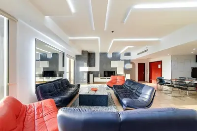 a living room with two couches and a table at Elan Rimal Suites JBR Beach Sea View in Dubai