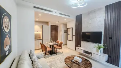 a living room with a couch and a table at STAY BY LATINEM Luxury 1BR Holiday Home CV B905 near Burj Khalifa in Dubai