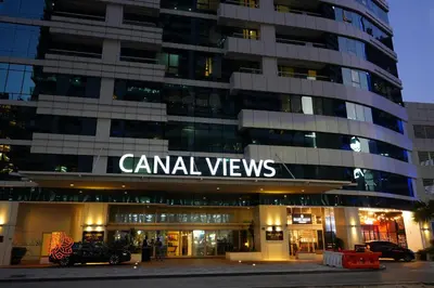 a building with a sign that reads camel views at Al Ashrafia Saray Marvelous 1 BR - Damac Maison - Canal View in Dubai