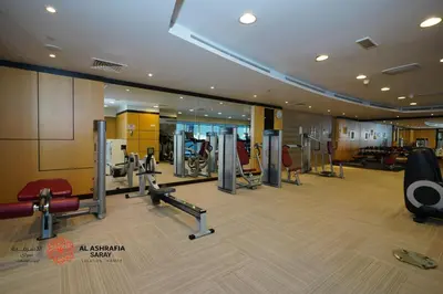 a gym with treadmills and cardio equipment in a building at Al Ashrafia Saray Marvelous 1 BR - Damac Maison - Canal View in Dubai