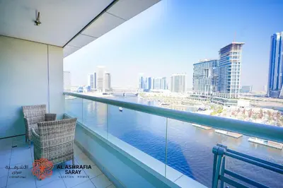 a balcony with a view of the water in a city at Al Ashrafia Saray Marvelous 1 BR - Damac Maison - Canal View in Dubai