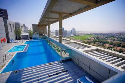 a swimming pool on the roof of a building at Unique 1BR Apartment in Sport City in Dubai