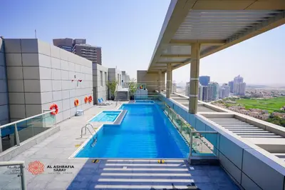 a swimming pool on the roof of a building at Unique 1BR Apartment in Sport City in Dubai