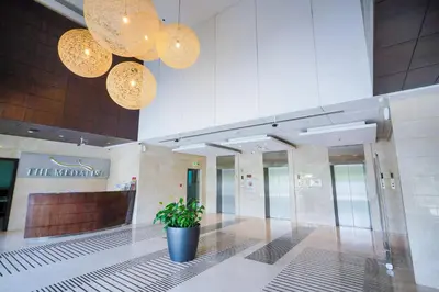 a lobby with a potted plant in a building at Unique 1BR Apartment in Sport City in Dubai