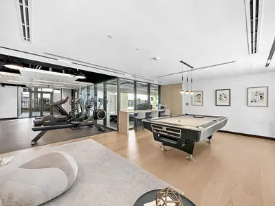 a living room with a pool table and a gym at Silkhaus brand new studio in Belgravia Heights, JVC in Dubai