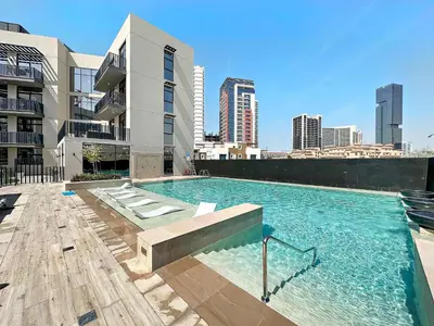 a large swimming pool on top of a building at Silkhaus modern studio in the heart of vibrant JVC in Dubai