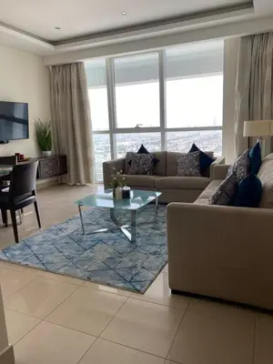 a living room with a couch and a table at Songs of the Lake by Lagom - Bonnington Apartment Jumeirah Lake Towers, in Dubai