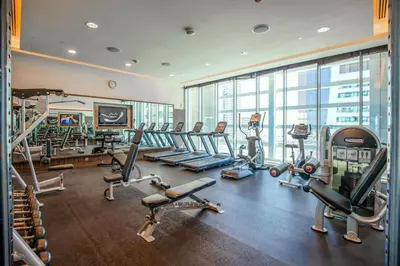 a gym with treadmills and cardio equipment in a building at Songs of the Lake by Lagom - Bonnington Apartment Jumeirah Lake Towers, in Dubai