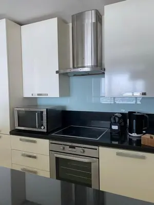 a kitchen with a microwave and a stove top oven at Songs of the Lake by Lagom - Bonnington Apartment Jumeirah Lake Towers, in Dubai