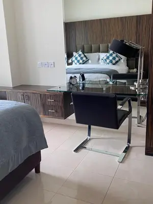 a bedroom with a glass desk and a bed at Songs of the Lake by Lagom - Bonnington Apartment Jumeirah Lake Towers, in Dubai