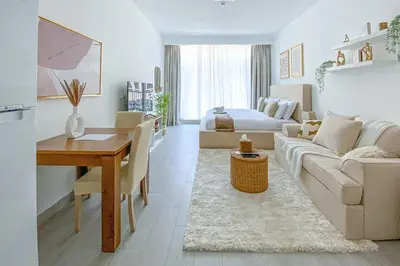 a living room with a couch and a table at Trophy - Urban Escape Suite in Dubai
