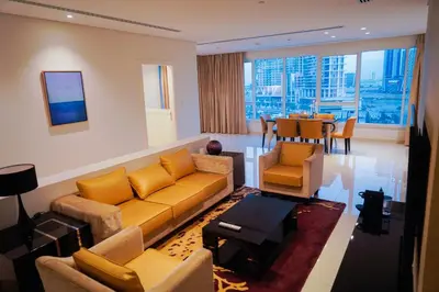 a living room with a couch and chairs and a table at Al Ashrafia Saray Magnificent 3BR Canal Views in Dubai