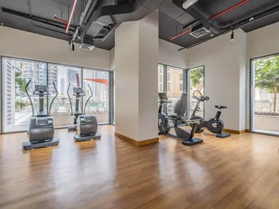 a gym with treadmills ellipticals and exercise bikes at Downtown Charming Condo Close to Dubai Mall in Dubai