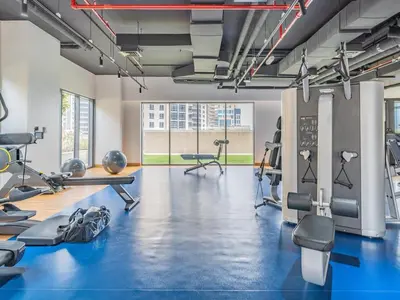 a gym with blue flooring and tread machines at Downtown Charming Condo Close to Dubai Mall in Dubai