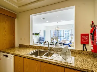 a kitchen with a sink and a large window at Downtown Charming Condo Close to Dubai Mall in Dubai