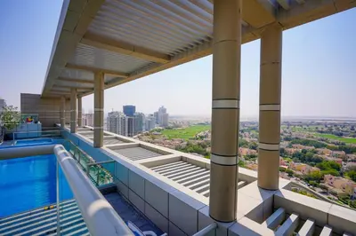 a view from the balcony of a building with a swimming pool at Alashrafia Saray 2BR apartment in Sport City in Dubai