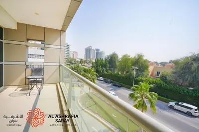a balcony of a building with a view of a street at Alashrafia Saray 2BR apartment in Sport City in Dubai