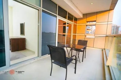 a dining room with a table and chairs at Alashrafia Saray, Lovely 2 BR apartment in Sport city in Dubai