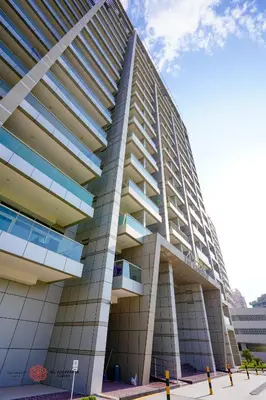 a tall building with balconies on the side of it at Alashrafia Saray, Lovely 2 BR apartment in Sport city in Dubai