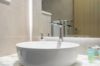 a white sink with a faucet in a bathroom at La Dolce Vita Residence by Suiteable Interiors in Dubai