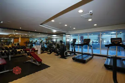 a gym with treadmills and cardio equipment in a building at Al Ashrafia Saray - Extraordinary Studio in Canal View in Dubai