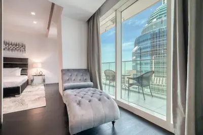 a bedroom with a bed and a large window at Damac Heights, Dubai Marina - Mint Stay in Dubai