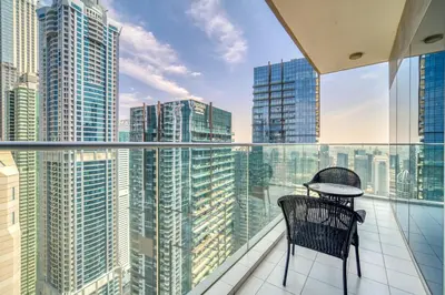 a balcony with a chair and a view of the city at Damac Heights, Dubai Marina - Mint Stay in Dubai