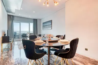 a dining room with a table and chairs at Damac Heights, Dubai Marina - Mint Stay in Dubai
