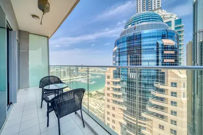 a balcony with two chairs and a table at Damac Heights, Dubai Marina - Mint Stay in Dubai