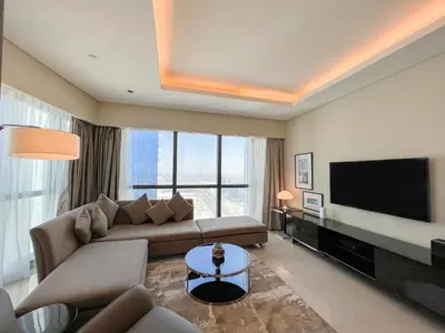 a living room with a couch and a flat screen tv at Luton Vacation Homes - Damac Paramount 2BR High Floor, Business Bay, Dubai 61AB06 in Dubai