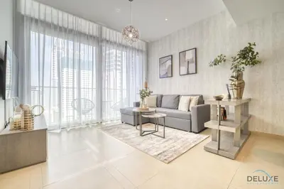a living room with a couch and a table at Surreal 1BR at The Residence Marina Gate 2 Dubai Marina by Deluxe Holiday Homes in Dubai